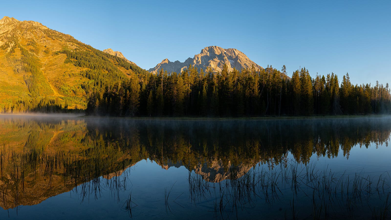 The Teton Range reflected in a lake near Jackson, Wyoming, in autumn